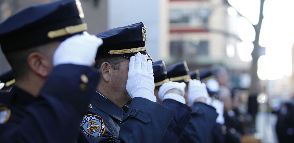 Police officers saluting in dress blues