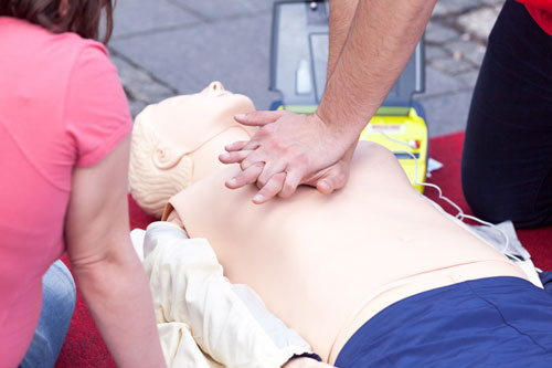Students practicing CPR with dummy
