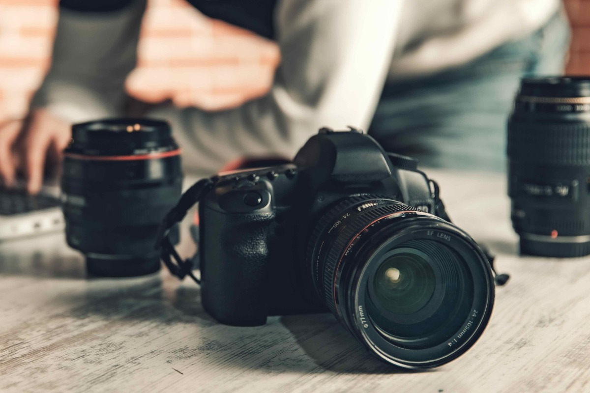 black DSLR camera on a grey desk