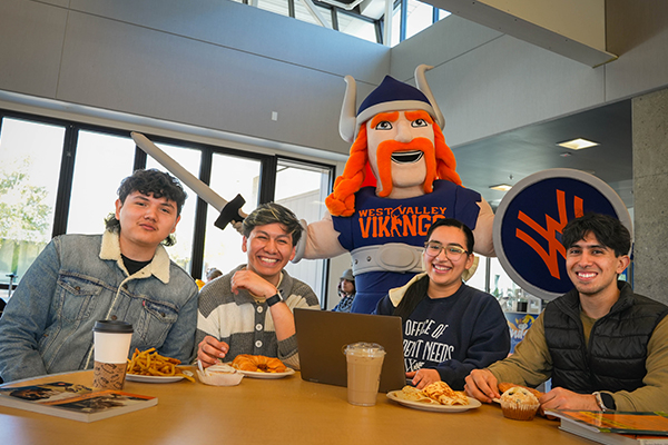 west valley college students enjoying a meal with mascot in background
