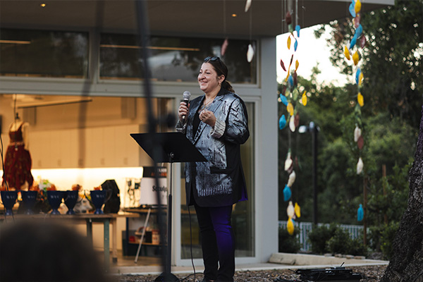 dean shannon mirabelli-lopez speaking at a podium