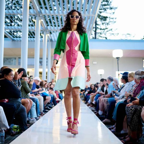 Department of Design a fashion model walking down a catwalk weating student designed clothing