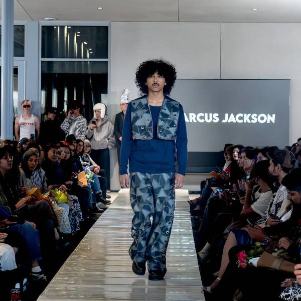 Department of Design a fashion model walking down a catwalk weating student designed clothing