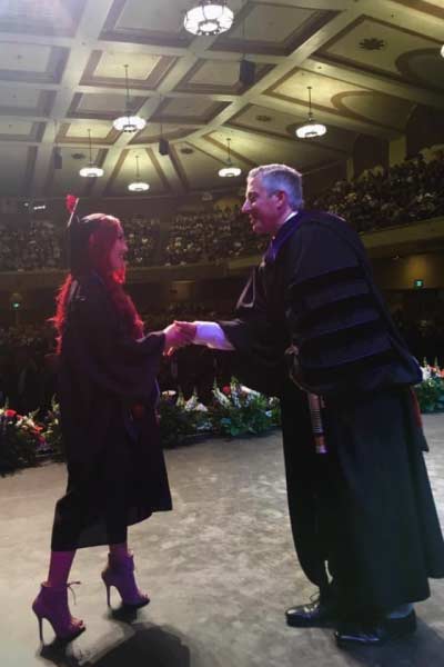 Brad with graduate on stage