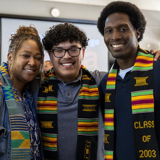 three people smiling