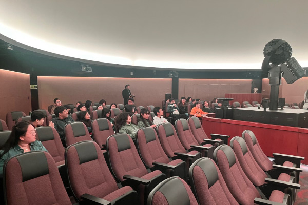 A group of people sitting in an auditorium.