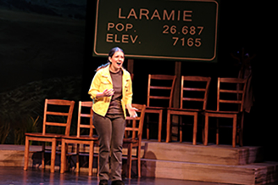 Actor acting on stage with dim lights