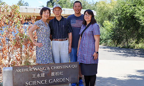 Wang and Qu outside of garden