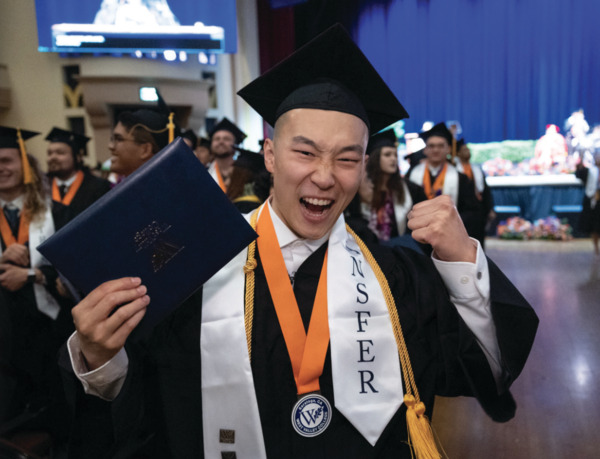 Male graduate celebrating with diploma