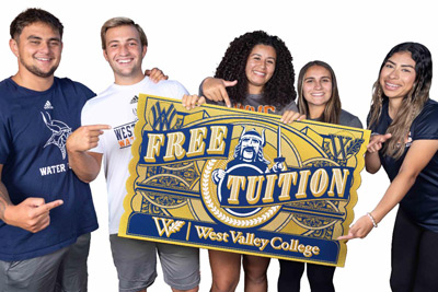 Students holding free tuition sign